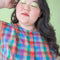 up close of model wearing colorful plaid button front cotton tank