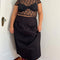 model wearing black twill midi skirt with wavey hem detail