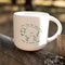 white ceramic mug with green buffalo that says 'much like the mighty buffalo, i have no f***ing money