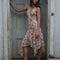 model wearing pink floral midi dress with layered hem, bow detail and v-neckline
