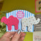 model holding packaged pink and white animal cookie hair clips with multicolor rhinestone details