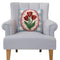 blue square throw pillow with red tulip print on a chair