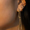up close of model wearing gold chain 'slipknot' jacket earrings