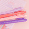 up close of set of 4 pink and purple gel pens with book themed saying on the side