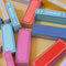 scattered colorful tumbling book game with wooden pieces that looks like book covers