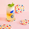 cream set of 4 coasters with colorful all over geometric shapes with a drink on one