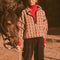 model wearing tan fleece half zip sweatshirt with red floral print and black piping on the arms and zipper