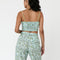 back view of model wearing mint cropped tank with dainty blueberry vine print and wide leg pants