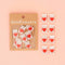 set of 8 cream sewing labels with a red heart in the center