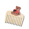 cream pocket comb with teddy bear holding a red heart on the top