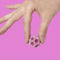 model holding various shades of pink mini magnet fidget toy 