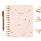 light pink and colorful grid notebook with gold foil 'professional overthinker - it will be okay' across the front surrounded by pen and gold binder clips