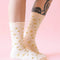 model wearing cream scalloped socks with glittery star print
