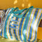 blue, white and yellow plaid large recycled plastic tote bag with ric rac detail and  embroidered three fishies on the front pocket on a bench