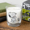 cinnamon scented candle with snoopy and wooodstock in a mummy outfit on a table