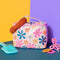 cream large leatherette cosmetic case with colorful floral print surrounded by hair accessories