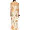 back view of model wearing cream maxi dress with all over colorful seashell print