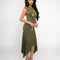side view of model wearing green midi dress with handkerchief hem and strategically placed starfish and seashell designs 