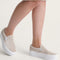 model wearing oatmeal suede classic slip on stackform shoes