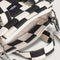 up close of black and white checkered small tote bag with white adjustable strap