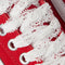 up close of red old skool sneaker with white and red lace laces