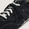 up close of black vans super low pro trainer sneakers  with white laces