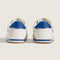 back view of white vans super low pro sneaker with royal blue trim and iconic stripe