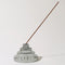 grey stacked glass incense holder with an incense inside