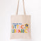 model holding canvas 'i break for little libraries' tote bag