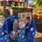 blue quilted tote with colorful folk print with items inside