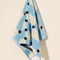 hanging light blue and white checkered terry cloth towel with black star print