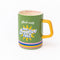 green ceramic mug with yellow handle and 'made with 100% creative fuel!' on the back with 'just a few more pages!' on the inside