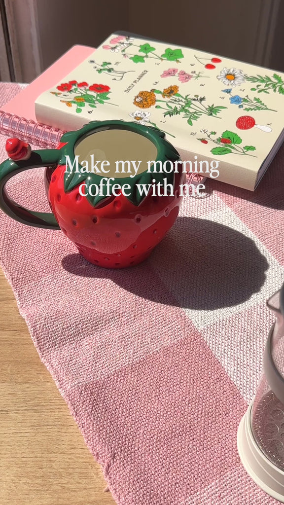 model making coffee in strawberry shaped mug
