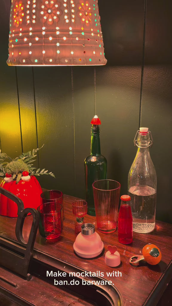 model making a mocktail with barware set