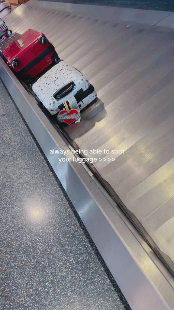 howdy shaked luggage tag on suitcase going through suitcase