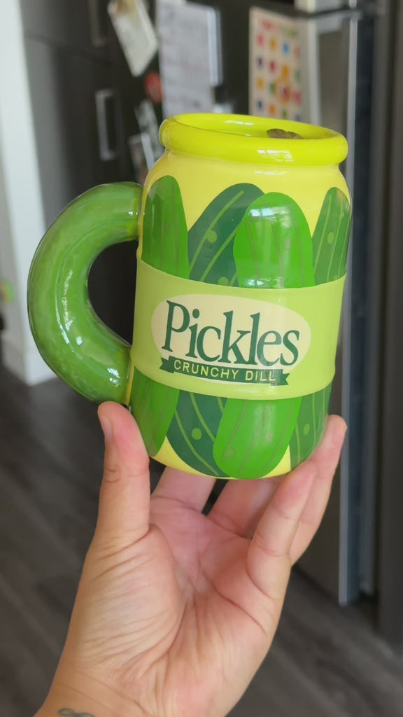 model showcasing pickle jar mug with pickles inside