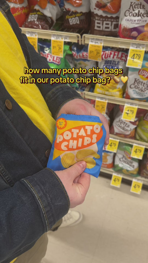 model putting 5 bags of potato chips in a realistic potato chip print shopper bag