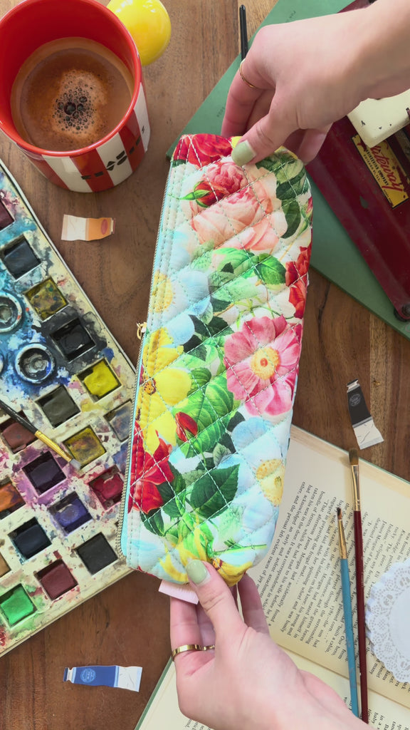 model showcasing colorful floral quilted pencil case