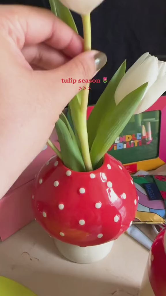 video of arranging white tulips in the mushroom vase
