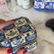 model filling blue and white folk print jewelry organizer with jewelry inside