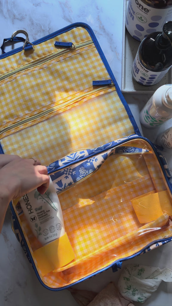 model filling blue and yellow travel bag
