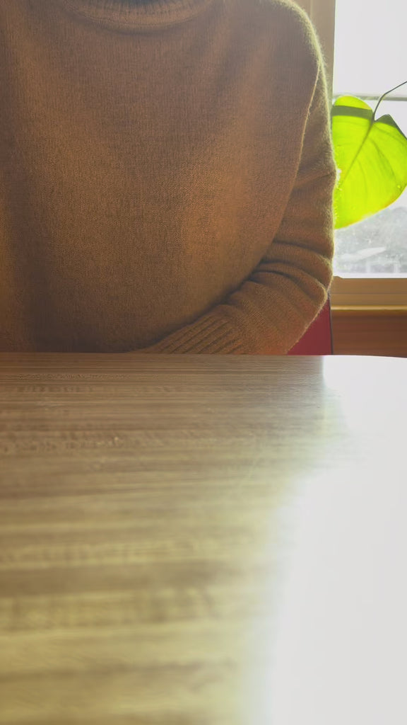 model drinking  out of smiley ceramic mug