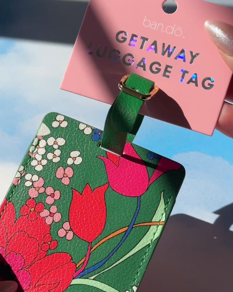 model showcasing emerald green floral luggage tag