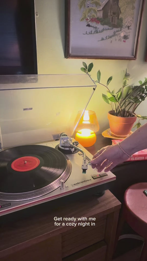 model getting ready to read a book with green colorful patchwork blanket