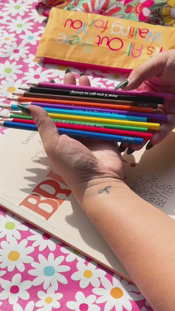 video of flipping through the coloring book and coloring in one of the pages