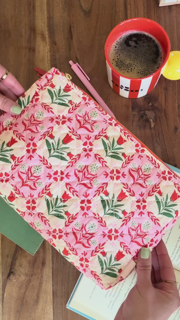 model showcasing pink folk floral quilted pouch