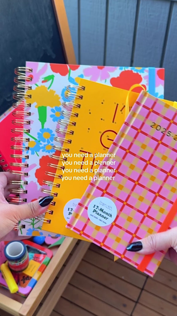 model showing colorful planners in classic, medium and large sizes