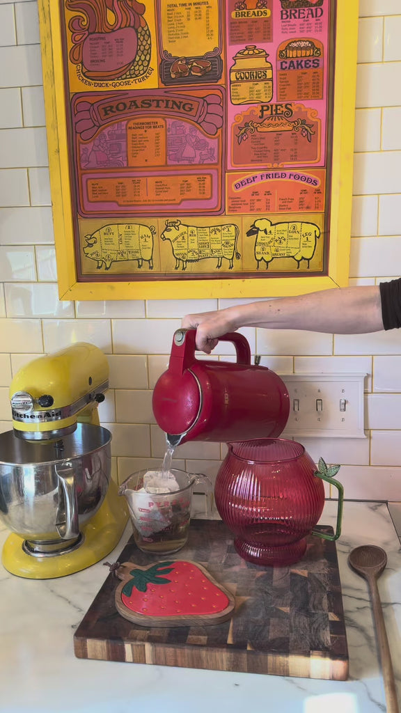model making sweet tea with apple shaped pitcher and strawberry trivet