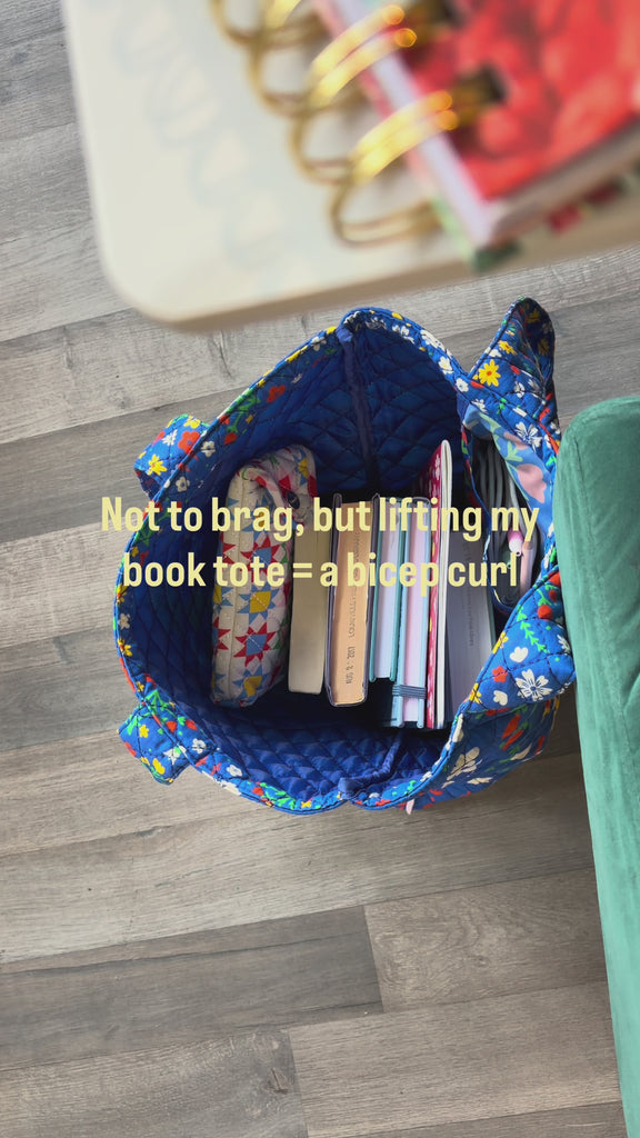 model filling blue tote bag with books!