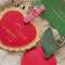 model showcasing set of 2 leatherette luggage tags with red heart that says 'cute little luggage tag' and tag shaped as a cherry
